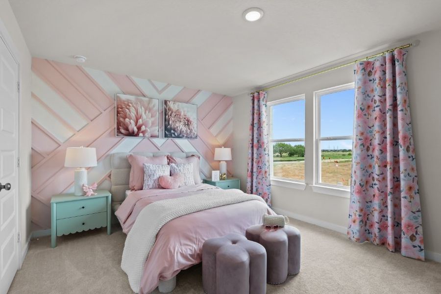 A bedroom with a pink bed and pink curtains. A bedroom with a pink bed and pink curtains.