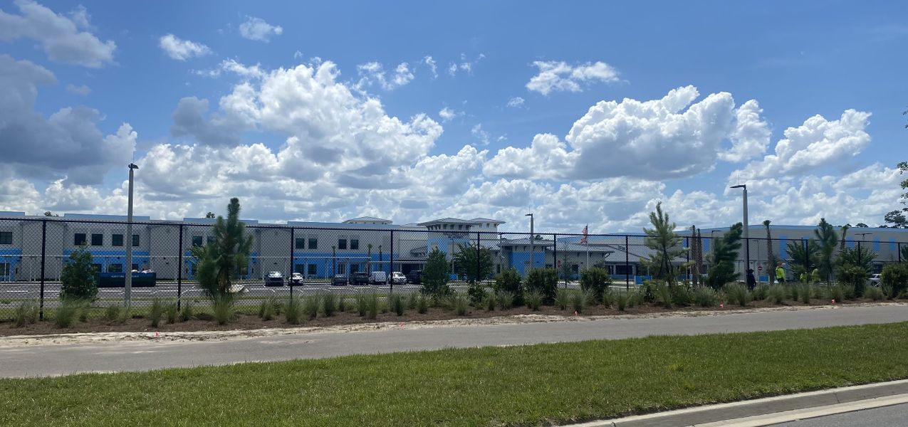 Modern community center with sleek design and lush landscaping in RiverTown - Bluffs by Mattamy Homes (St. Johns, FL). Modern community center with sleek design and lush landscaping in RiverTown - Bluffs by Mattamy Homes (St. Johns, FL).