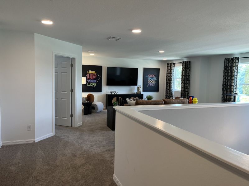 A cozy living area featuring plush seating, modern decor, and playful wall art, ideal for relaxation and entertainment.