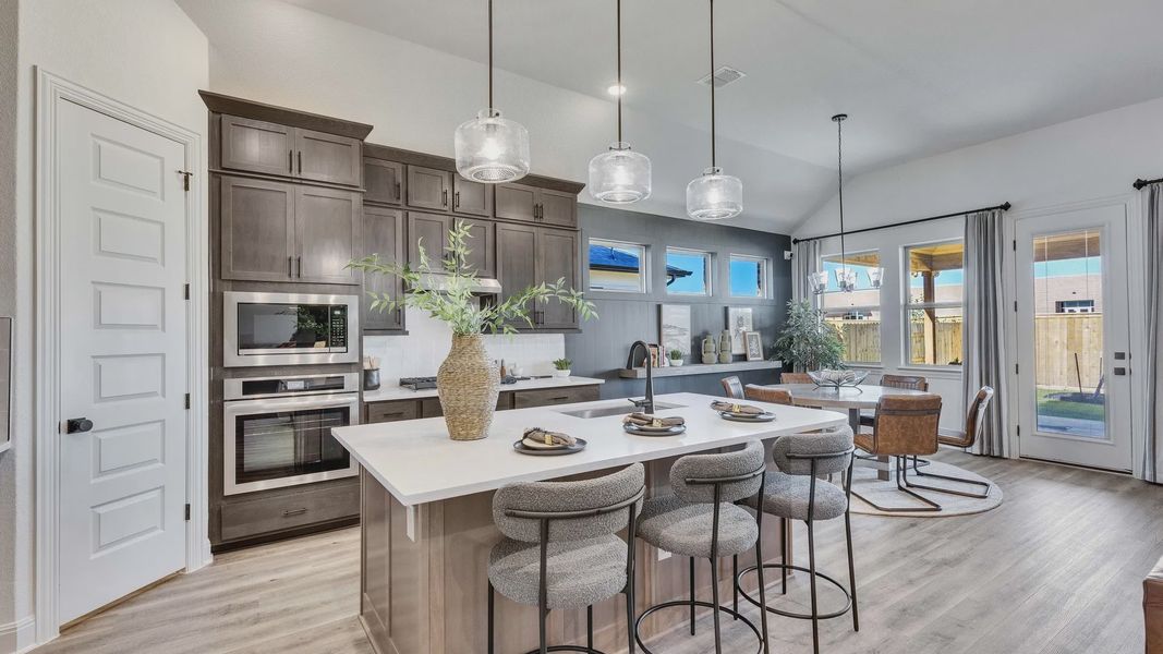 Elegant marble island and sophisticated gray cabinetry define this Briarwood home’s luxury kitchen.