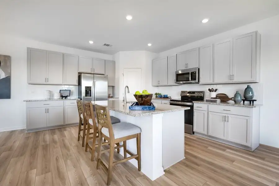 Furnished interior in a model home at Stonewall Ranch 40s in Liberty Hill (Image 26).