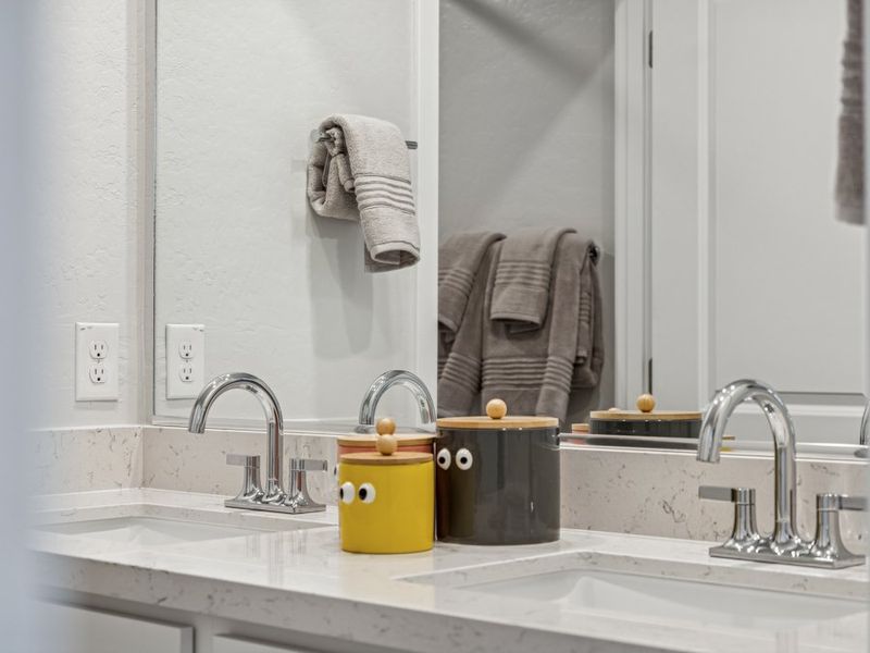 A bathroom with a mirror and towels.