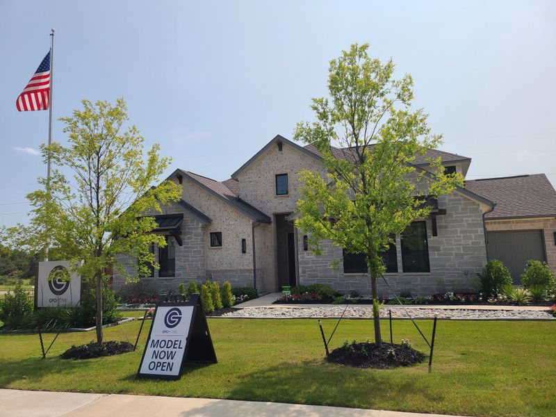 A beautiful stone home with lush landscaping in Oaks Preserve by GFO Home, Mansfield, TX. A beautiful stone home with lush landscaping in Oaks Preserve by GFO Home, Mansfield, TX.