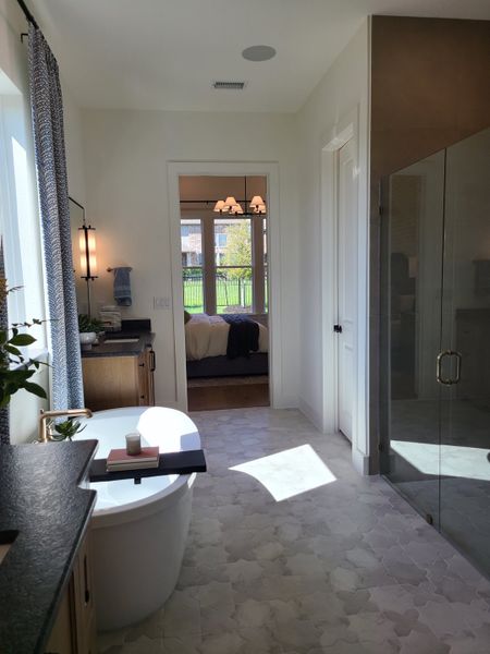 A bright bathroom with a freestanding tub, modern fixtures, and a large glass shower. A bright bathroom with a freestanding tub, modern fixtures, and a large glass shower.