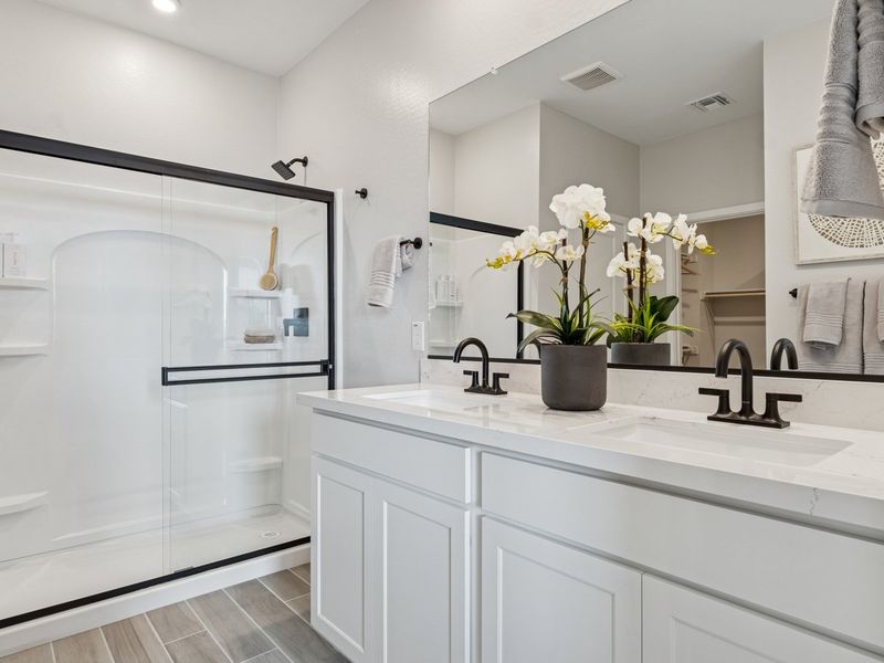 A bathroom with white cabinets.