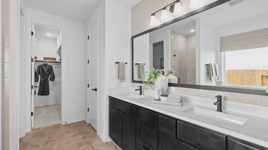 Elegant black cabinetry, geometric pattern flooring, and sleek fixtures elevate this River Ranch bathroom retreat. Elegant black cabinetry, geometric pattern flooring, and sleek fixtures elevate this River Ranch bathroom retreat.