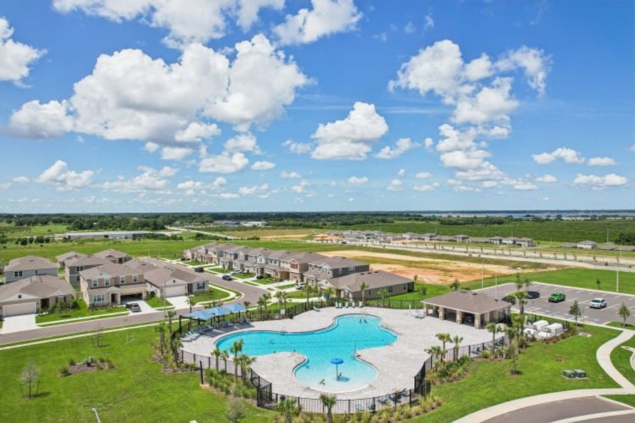 A large building with a pool in front of it.