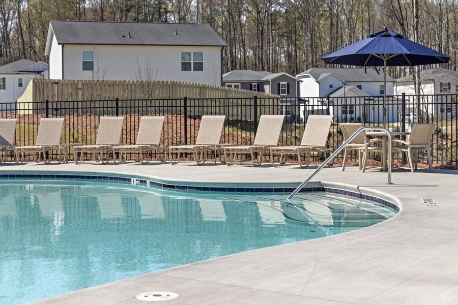 A pool with chairs around it. A pool with chairs around it.