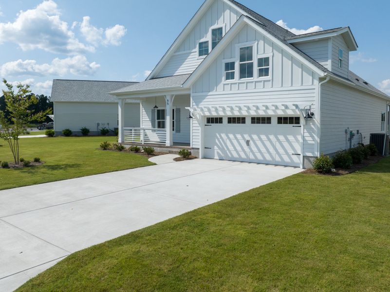 Front exterior of a home in the Songbird community, located in Hampstead, NC (Image 10). Front exterior of a home in the Songbird community, located in Hampstead, NC (Image 10).