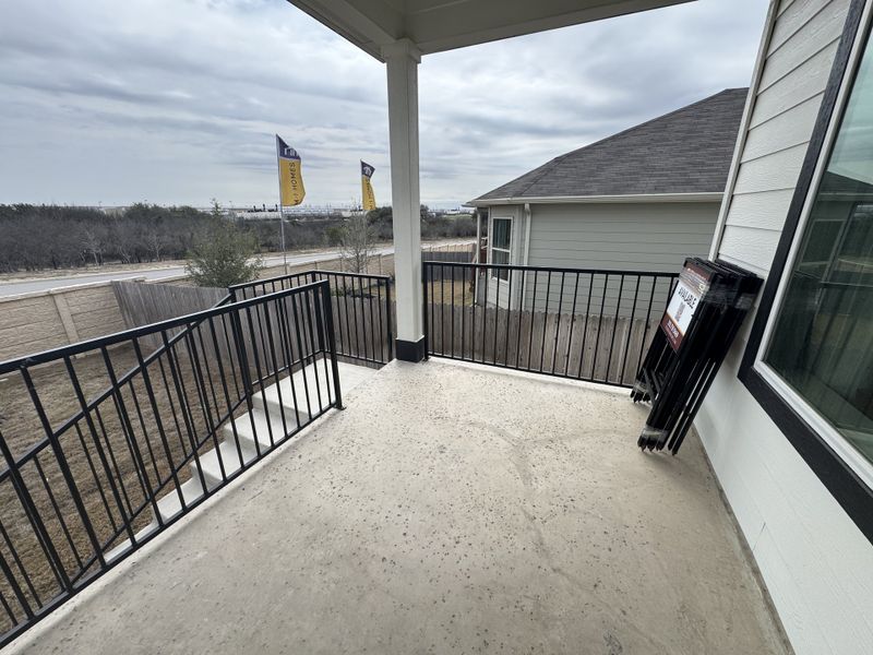A spacious balcony with metal railing overlooking the neighborhood in Hunters Ranch - The Meadows by View Homes (San Antonio, TX). A spacious balcony with metal railing overlooking the neighborhood in Hunters Ranch - The Meadows by View Homes (San Antonio, TX).