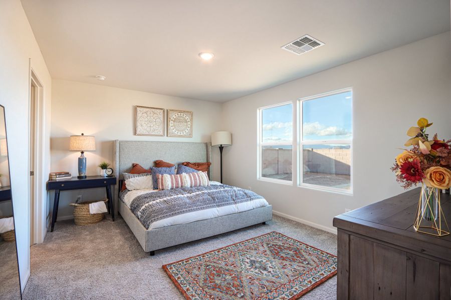 A bedroom with a large window. A bedroom with a large window.