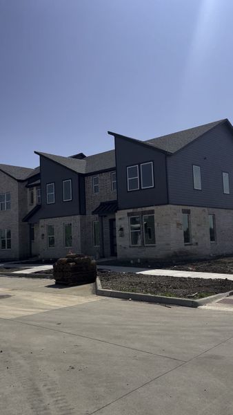 A contemporary gray duplex with stone accents in Rose Place by Aspen Square Homes (Frisco, TX). A contemporary gray duplex with stone accents in Rose Place by Aspen Square Homes (Frisco, TX).