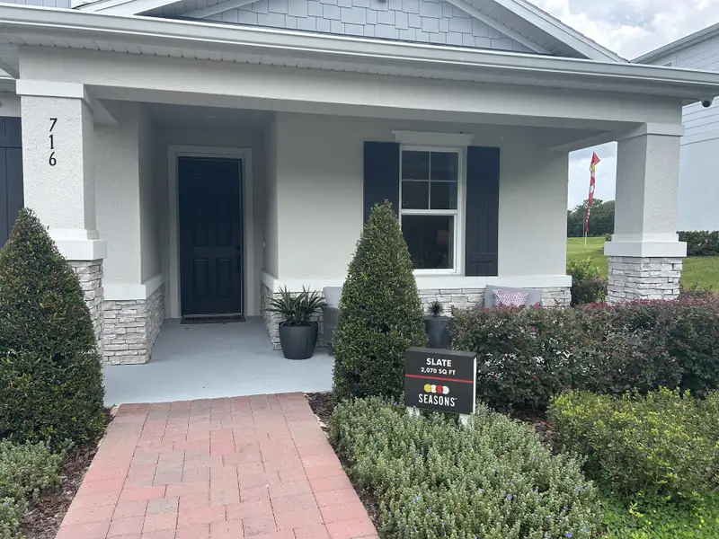 A charming home with a cozy porch and manicured landscaping in Seasons at Wekiva Ridge by Richmond American Homes (Mount Dora, FL). A charming home with a cozy porch and manicured landscaping in Seasons at Wekiva Ridge by Richmond American Homes (Mount Dora, FL).