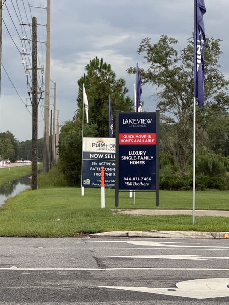 Street view of Summer Bay at Grand Oaks by Pulte Homes in St. Augustine, FL, featuring luxury homes and lush greenery. Street view of Summer Bay at Grand Oaks by Pulte Homes in St. Augustine, FL, featuring luxury homes and lush greenery.