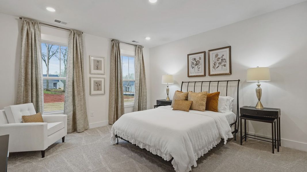 New two story home with secondary bedroom with elevated ceilings, large windows & plush carpet at Pinebrook by DRB Homes New two story home with secondary bedroom with elevated ceilings, large windows & plush carpet at Pinebrook by DRB Homes