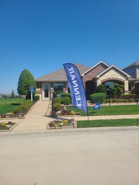 A charming brick home with manicured landscaping in Northlake Estates: Brookstone Collection by Lennar (Little Elm, TX).