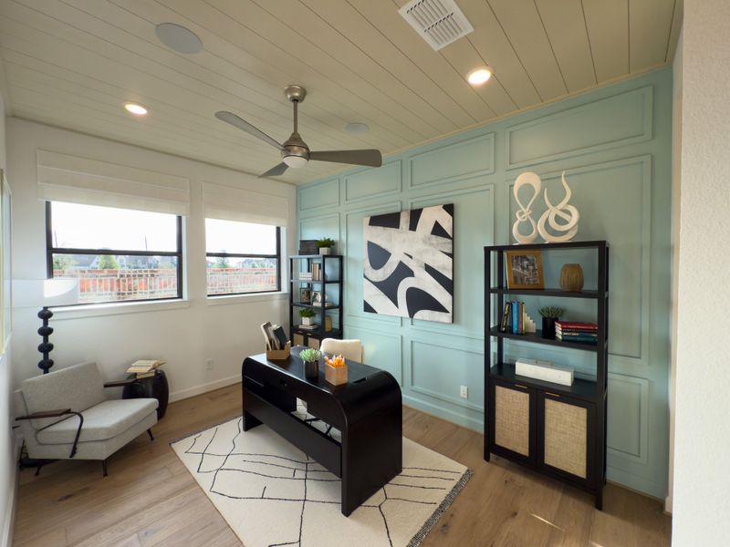 A modern office space with a sleek desk, pastel accent wall, and stylish shelving. A modern office space with a sleek desk, pastel accent wall, and stylish shelving.