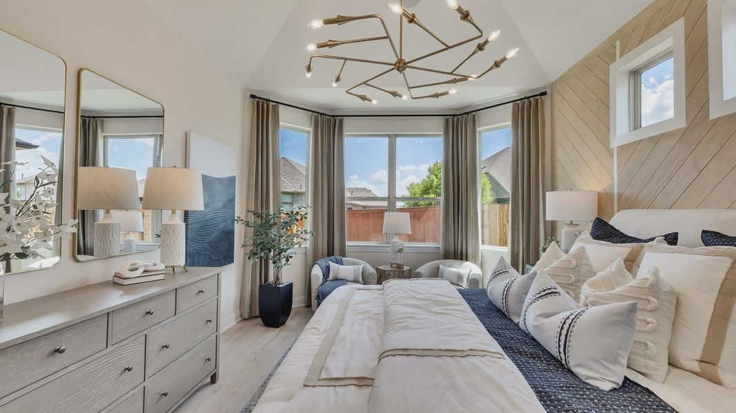 Sunfield bedroom boasts vaulted ceilings, chic lighting, and lavish decor. A serene, luxurious oasis awaits you. Sunfield bedroom boasts vaulted ceilings, chic lighting, and lavish decor. A serene, luxurious oasis awaits you.