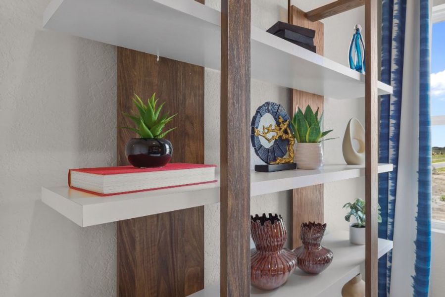 A shelf with vases and plants.