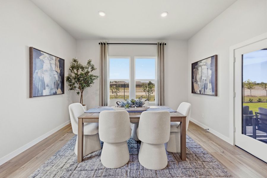 A dining room with a large table. A dining room with a large table.