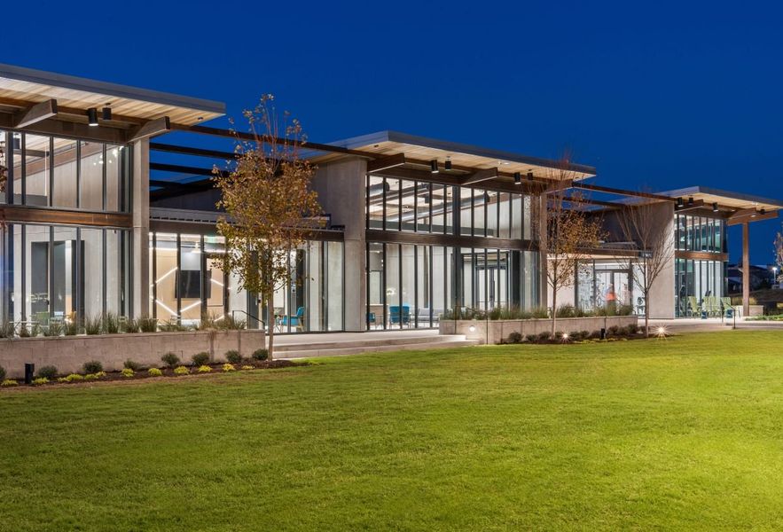 Twilight photo of the exterior of amenity center in Mosaic, Celina, Texas