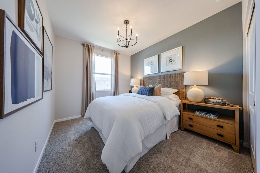 A bedroom with a bed and a dresser.