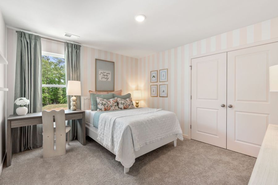 A bedroom with a bed and a desk.