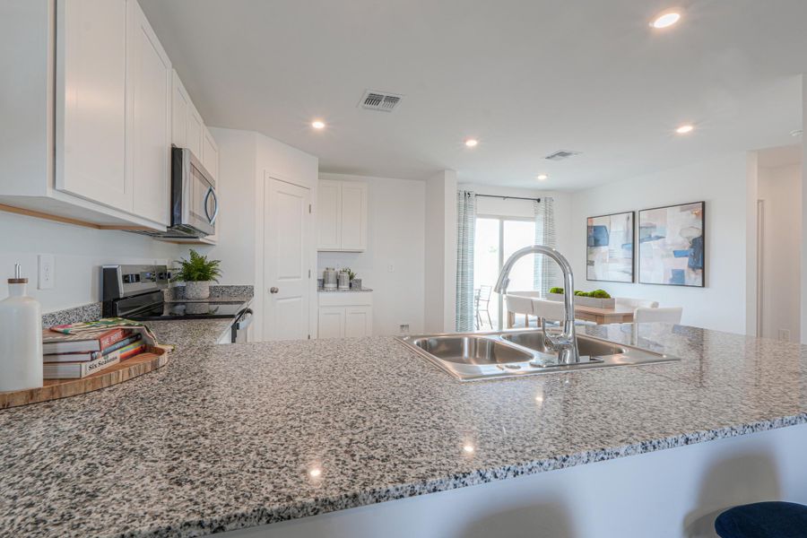 A kitchen with marble counters. A kitchen with marble counters.