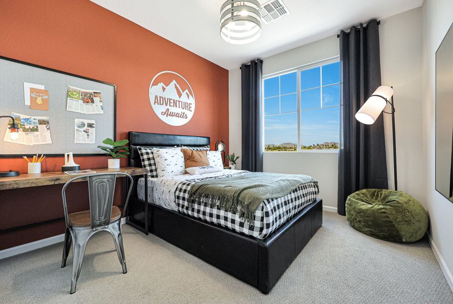 A bedroom with a bed and a desk. A bedroom with a bed and a desk.