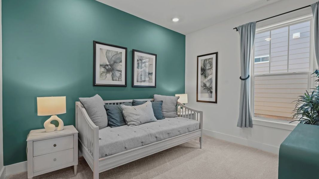 DRB Homes' Pelham Crossing with plush carpeted secondary bedroom and green accent wall in Greenville, SC