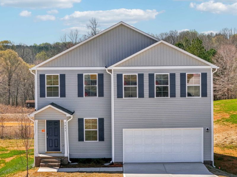 A grey house with a garage.