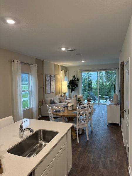 A cozy open-plan kitchen and living area with modern decor, scenic view, and inviting dining space. A cozy open-plan kitchen and living area with modern decor, scenic view, and inviting dining space.