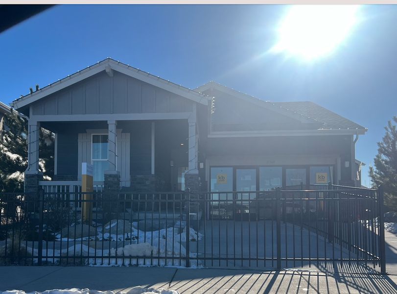 A charming home with a modern porch in Painted Prairie by KB Home (Aurora, CO).