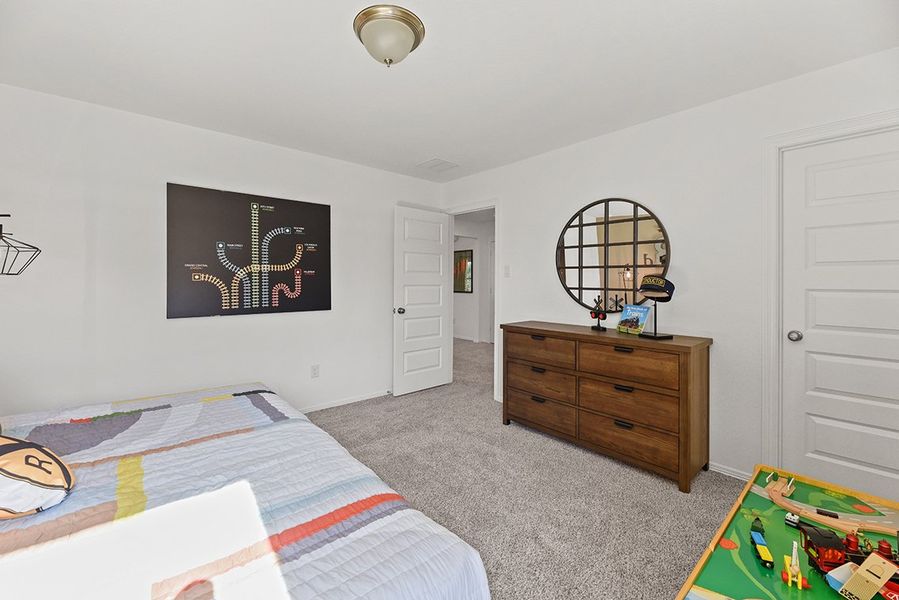 A bedroom with a bed and dresser. A bedroom with a bed and dresser.