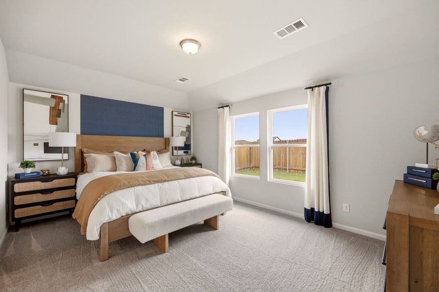 A bedroom with a large window. A bedroom with a large window.