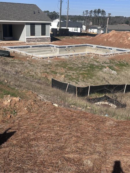A spacious backyard with a new pool under construction in Alcovy Village by Rockhaven Homes (Lawrenceville, GA).