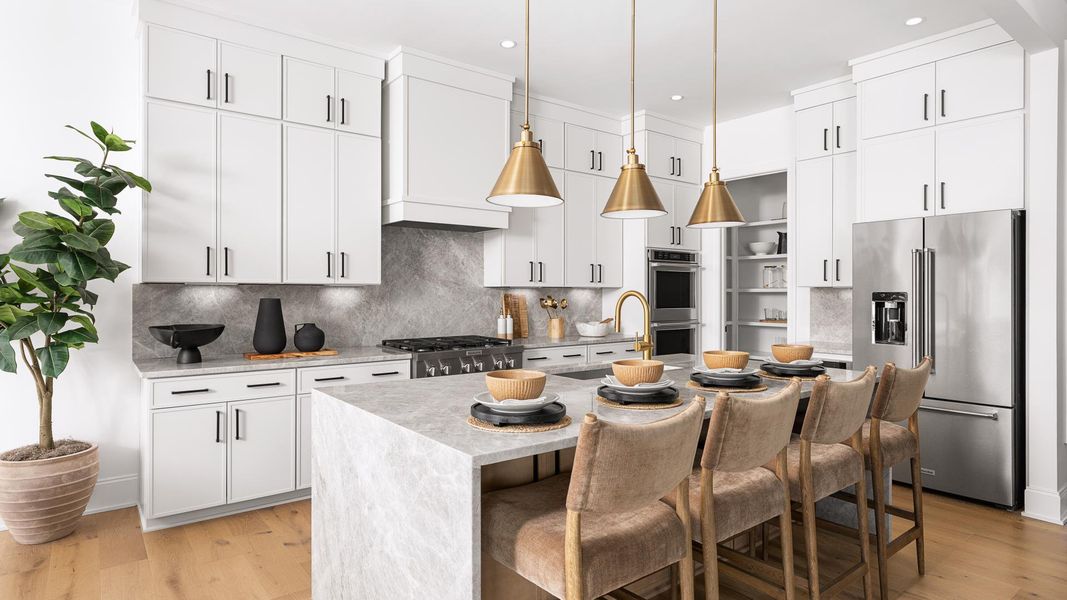Gourmet kitchen boasts a large center island and stainless steel appliances