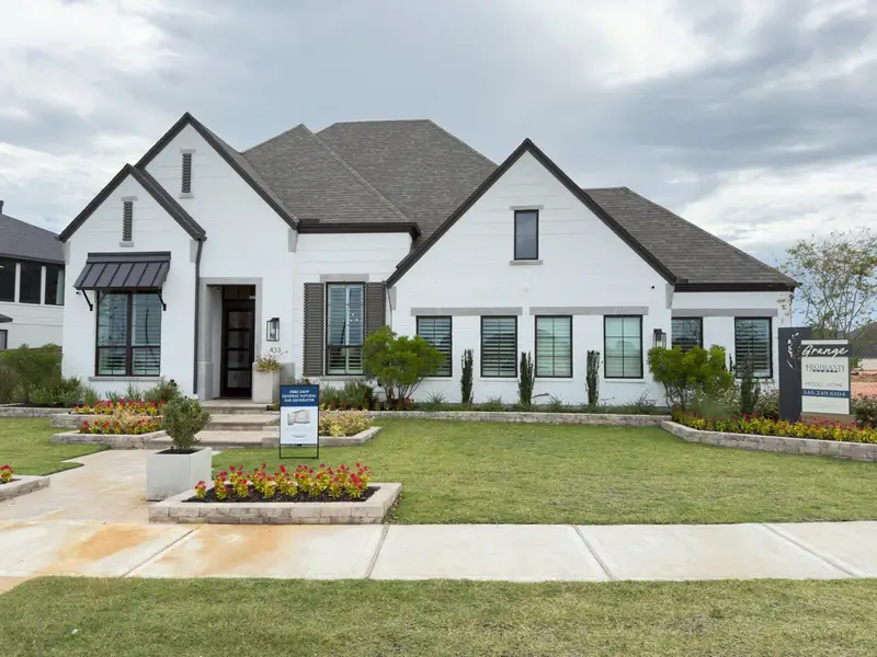 A charming white brick home with manicured landscaping in Grange by Highland Homes, located in Katy, TX. A charming white brick home with manicured landscaping in Grange by Highland Homes, located in Katy, TX.