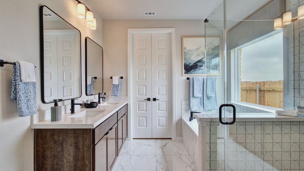 Indulge in luxury with marble tile floors and frameless glass shower in Sunflower Ridge.