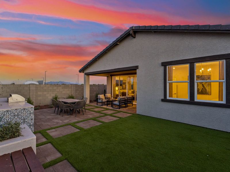 A house with a patio and a grass yard.