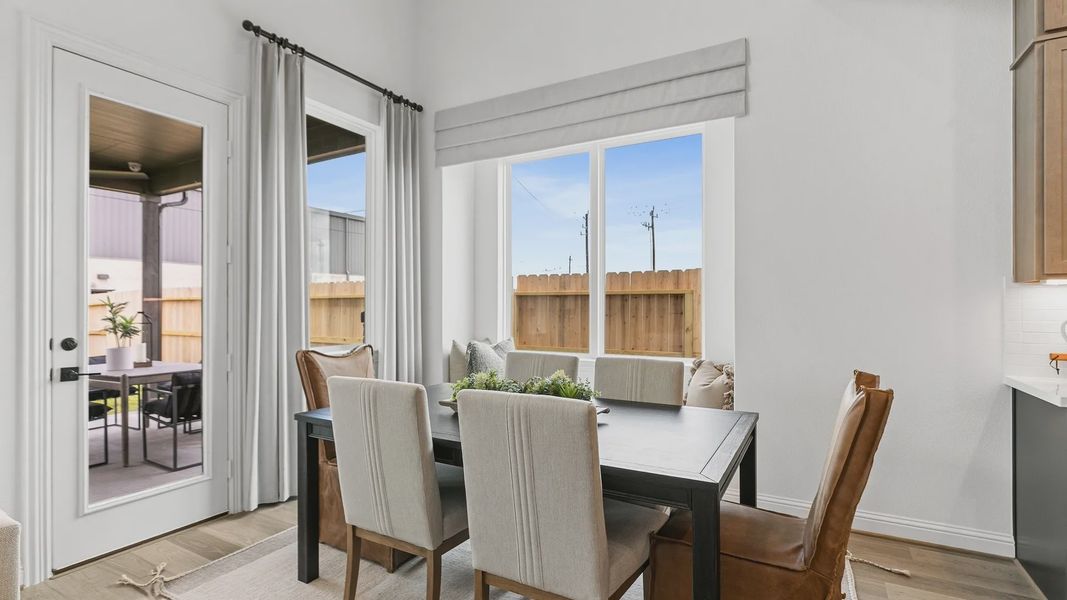 Experience refined dining in a sunlit space, showcasing expansive windows and exquisite attention to detail. Beamer Villas. Experience refined dining in a sunlit space, showcasing expansive windows and exquisite attention to detail. Beamer Villas.