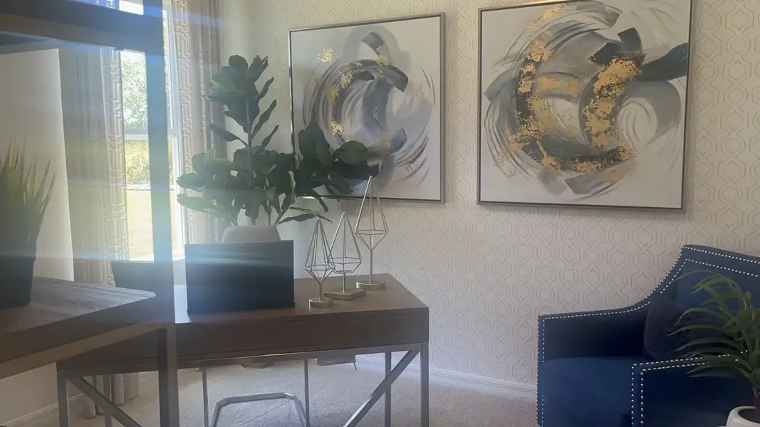 A chic office with abstract art, modern décor, and abundant natural light.