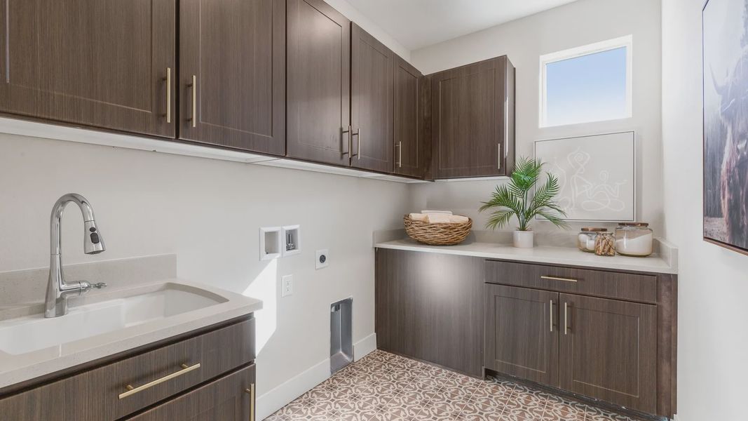 Dillon Pointe laundry features luxurious dark wood cabinetry and artisanal tile flooring, epitomizing modern design. Dillon Pointe laundry features luxurious dark wood cabinetry and artisanal tile flooring, epitomizing modern design.