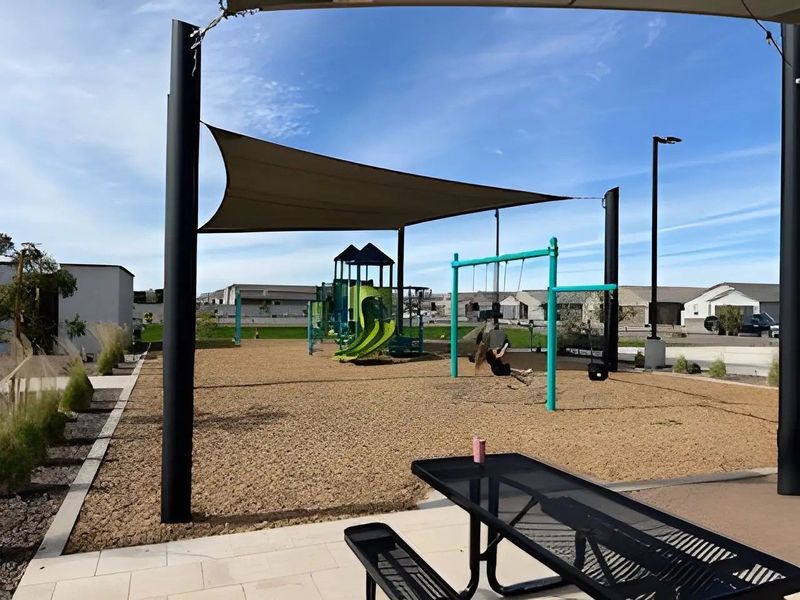 Family playground with vibrant green slides and swings in Bella Vista Trails Reserve Series by Meritage Homes (San Tan Valley, AZ). Family playground with vibrant green slides and swings in Bella Vista Trails Reserve Series by Meritage Homes (San Tan Valley, AZ).