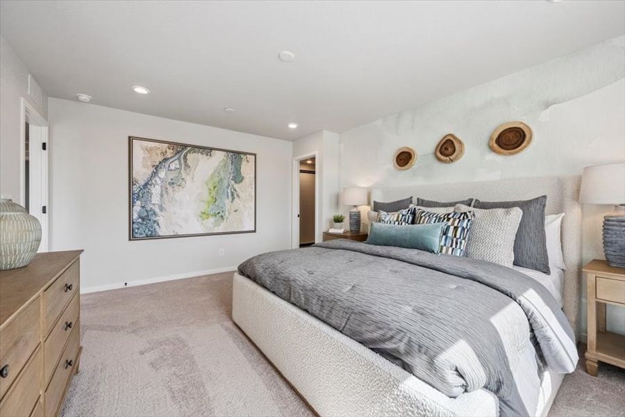 A bedroom with a bed and a painting on the wall.