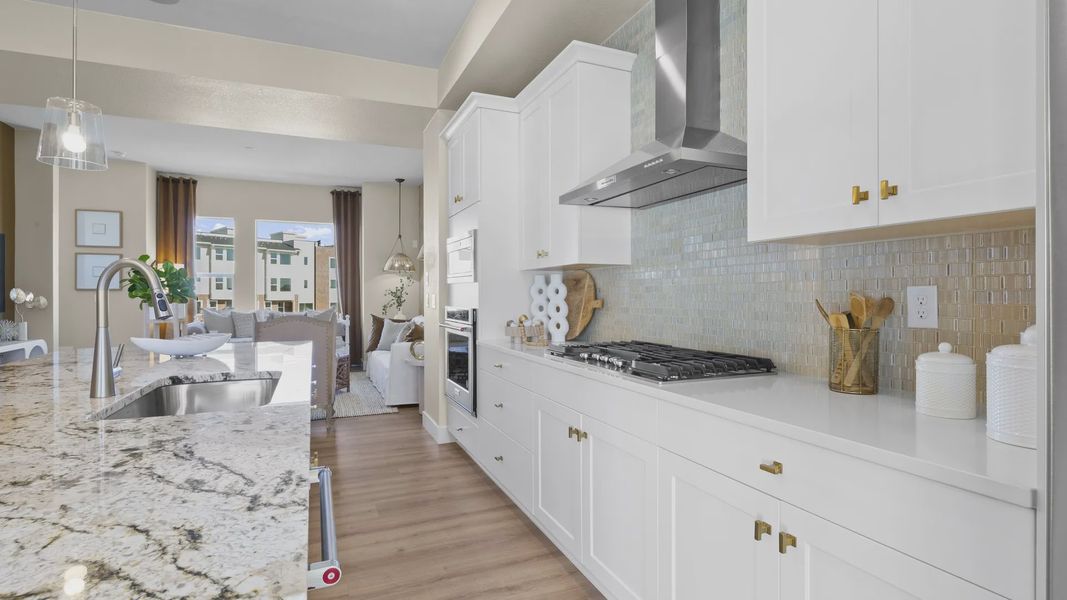 Granite countertops and custom cabinetry define this refined Dillon Pointe kitchen. [86]