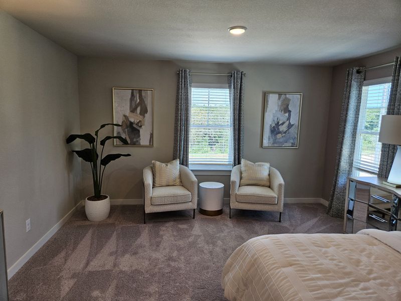 A cozy bedroom with plush carpet, stylish armchairs, abstract art, and natural light filtering through elegant curtains. A cozy bedroom with plush carpet, stylish armchairs, abstract art, and natural light filtering through elegant curtains.