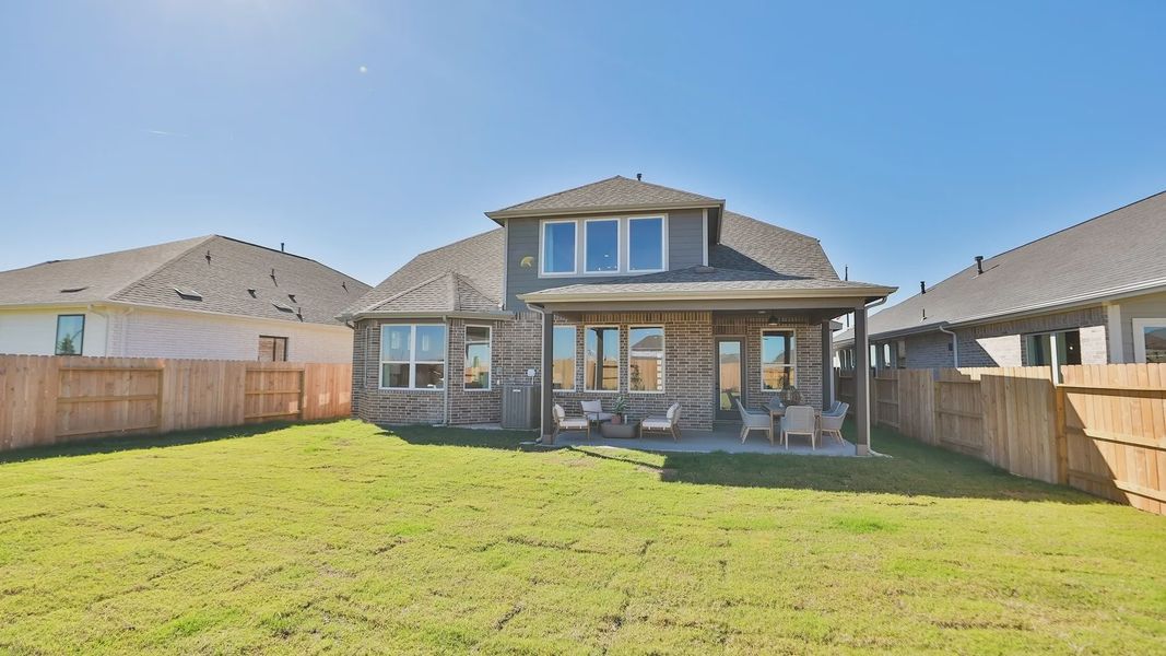 Elegant brick facade and covered patio highlight luxurious living in Brookewater community. Elegant brick facade and covered patio highlight luxurious living in Brookewater community.