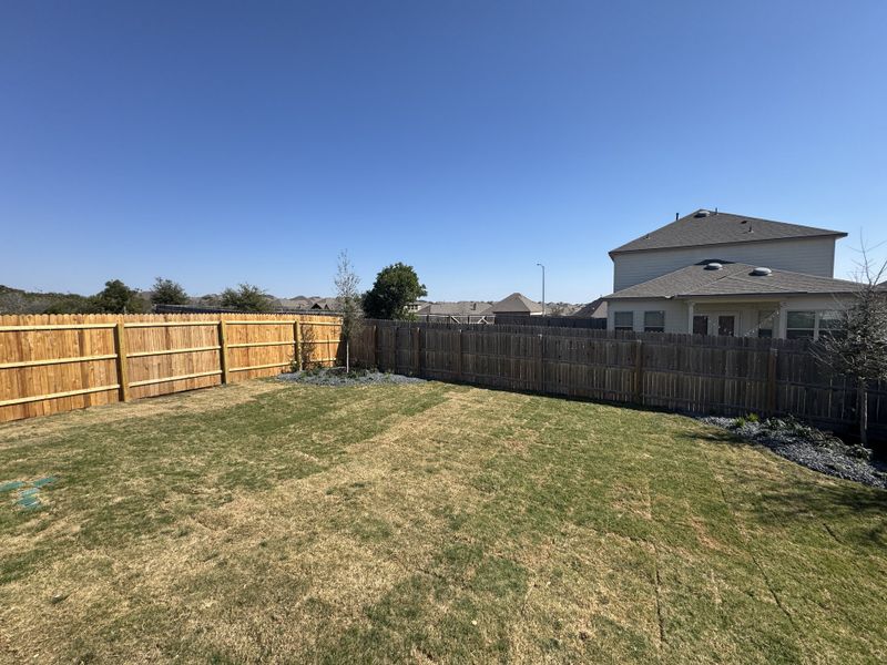 A spacious backyard with a wooden fence and clear blue skies in Weston Oaks by View Homes (San Antonio, TX). A spacious backyard with a wooden fence and clear blue skies in Weston Oaks by View Homes (San Antonio, TX).