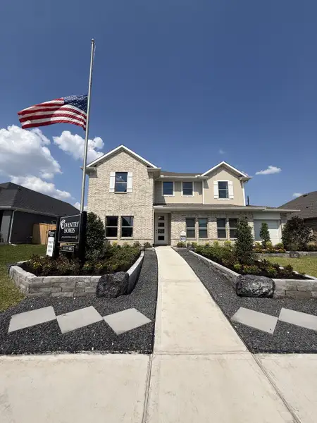 A beautiful brick home with manicured landscaping in Arabella on the Prairie by Coventry Homes (Richmond, TX). A beautiful brick home with manicured landscaping in Arabella on the Prairie by Coventry Homes (Richmond, TX).